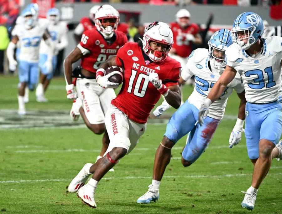 Nov 25, 2023; Raleigh, North Carolina, USA; North Carolina State Wolfpack receiver KC Concepcion (10) runs after a catch against North Carolina Tar Heels defensive back Will Hardy (31) during the first half at Carter-Finley Stadium. credits: Rob Kinnan-USA TODAY Sports