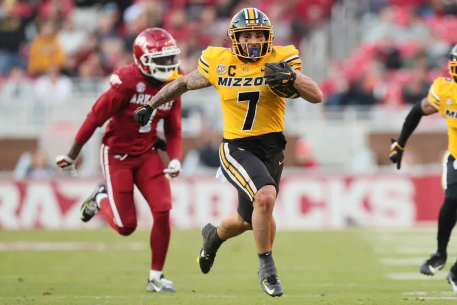 Nov 24, 2023; Fayetteville, Arkansas, USA; Missouri Tigers running back Cody Schrader (7) rushes against the Arkansas Razorbacks during the second quarter at Donald W. Reynolds Razorback Stadium. credits: Nelson Chenault-USA TODAY Sports