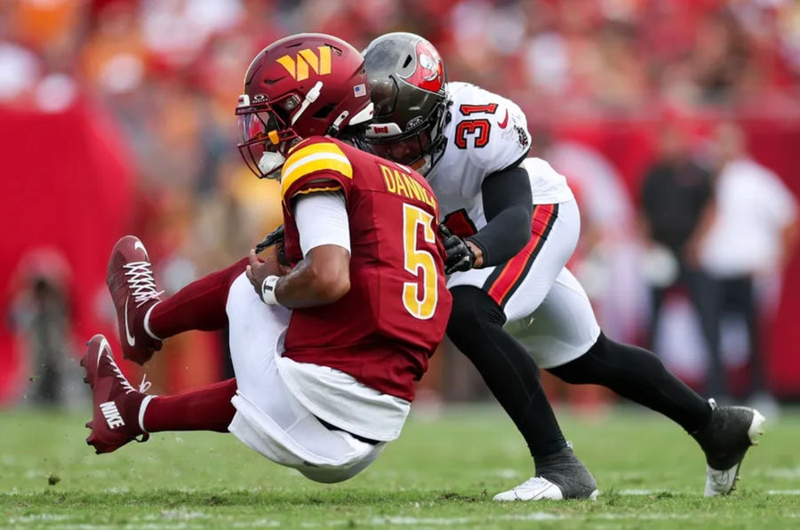 Sep 8, 2024; Tampa, Florida, USA; Washington Commanders quarterback Jayden Daniels (5) is hit by Tampa Bay Buccaneers safety Antoine Winfield Jr. (31) in the second quarter at Raymond James Stadium. Mandatory Credit: Nathan Ray Seebeck-Imagn Images