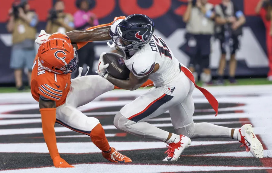 Sep 15, 2024; Houston, Texas, USA; Houston Texans wide receiver Nico Collins (12) scores a touchdown catch against Chicago Bears cornerback Jaylon Johnson (1) in the second quarter at NRG Stadium. Mandatory Credit: Thomas Shea-Imagn Images