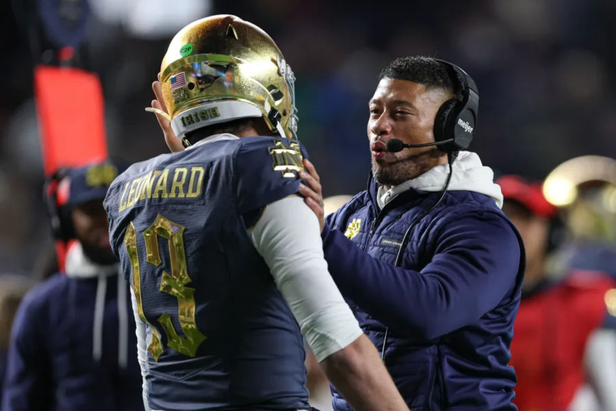Nov 23, 2024; New York, New York, USA; Notre Dame Fighting Irish head coach Marcus Freeman celebrates with quarterback Riley Leonard (13) after a touchdown during the first half against the Army Black Knights at Yankee Stadium. Mandatory Credit: Vincent Carchietta-Imagn Images