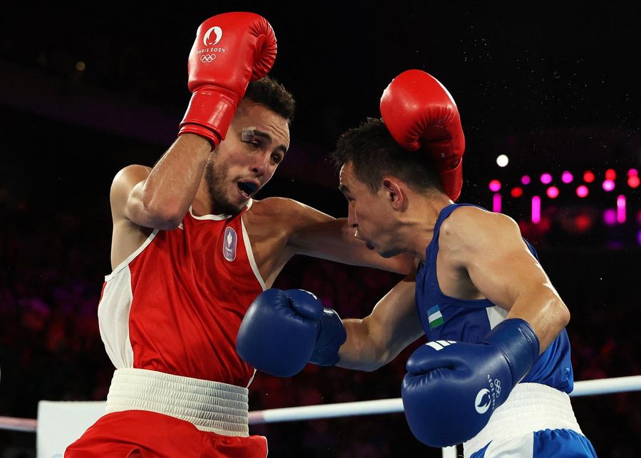 Uzbek boxer Hasanboy Dusmatov beats local favorite for gold