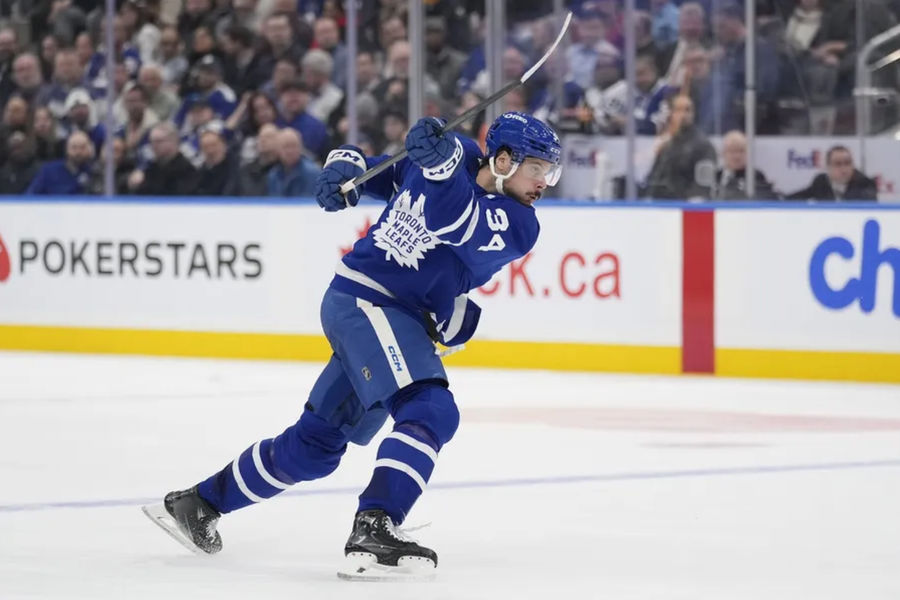 Dec 12, 2024; Toronto, Ontario, CAN; Toronto Maple Leafs forward Auston Matthews (34) shoots the puck against the Anaheim Ducks during the third period at Scotiabank Arena. Mandatory Credit: John E. Sokolowski-Imagn Images