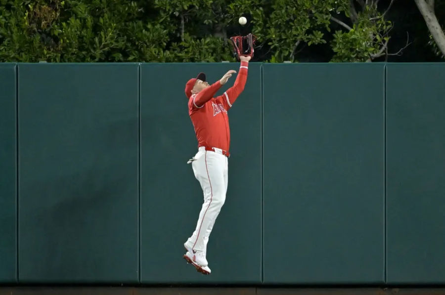 Apr 6, 2024; Anaheim, California, USA; Los Angeles Angels outfielder Mike Trout (27) makes a leaping catch at the wall off a fly ball hit by Boston Red Sox outfielder Jarren Duran (16) in the eighth inning at Angel Stadium. Mandatory Credit: Jayne Kamin-Oncea-Imagn Images
